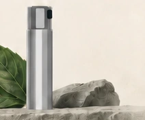 Compact silver oral spray atomizer.